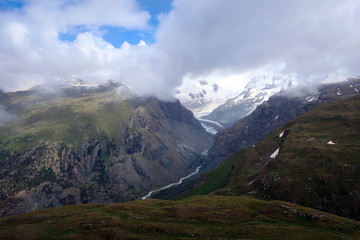 Fototapeta premium Cloudy Swiss Alps view high above Zermatt village near Matterhorn, Switzerland