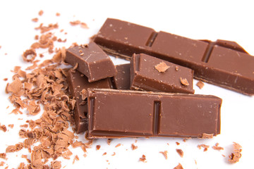 Milk chocolate pieces isolated on white background