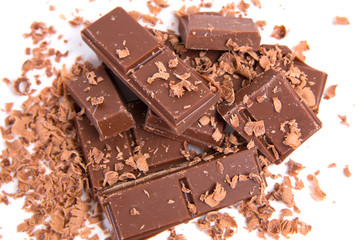 Milk chocolate pieces isolated on white background