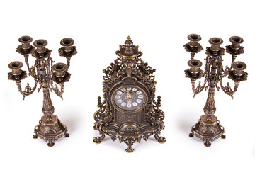 Vintage watch with two candelabra on white background