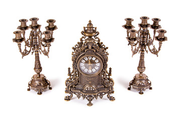 Vintage watch with two candelabra on white background