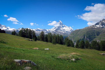 Scenic bright view of Matterhorn and clouds around, Swiss Alps near Zermatt