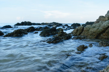 Fototapeta na wymiar Sea Water with Rocks at Surin Beach, Phuket, Thailand