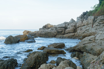 Rocks with Smooth Sea Water(wave) at Surin Beach, Phuket, Thailand