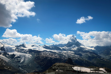 Fototapeta premium Scenic bright view of Matterhorn and clouds around, Swiss Alps near Zermatt