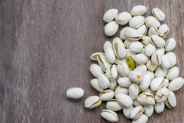 pistachios on wooden table background with copyspace