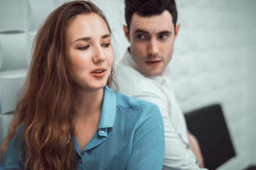 Cinematic tone of young handsome man trying to reconcile with his beautiful girlfriend after have...