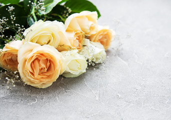Yellow and white roses on a stone background