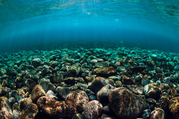 Underwater scene with stones, copy space. Ocean texture