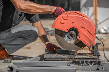 Metal cutting. Metal cutting with angle grinder.Man cuts metal