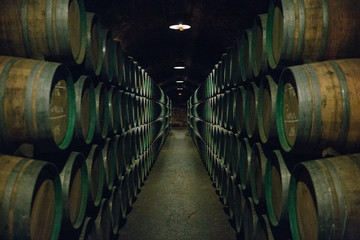 Wooden wine barrels stacked in a cellar