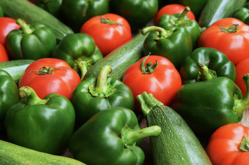 Cucumbers, tomatoes and sweet pepper on wooden table for background