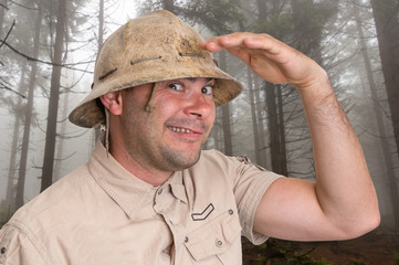 Man with helmet in scary forest in fog
