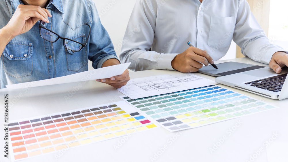 Fototapete team of colleague graphic designer drawing and retouching image on graphics tablet and choose color 