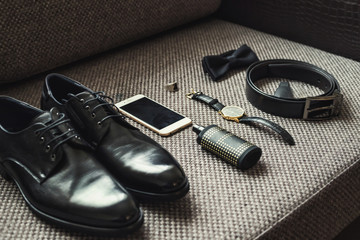 different accessories of a businessman for creating a style of a people lie on a wooden background