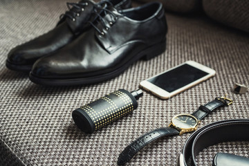 different accessories of a businessman for creating a style of a people lie on a wooden background