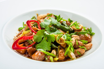 Chicken in Teriyaki sauce, batter, peppers, teriyaki sauce in a white plate