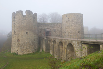 Fototapeta premium Koporye fortress close-up in the morning autumn fog. Leningrad region, Russia