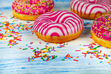 Donuts on a blue wooden background.