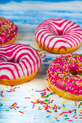 Donuts on a blue wooden background.