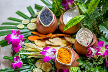 The massage or spa herbal set display in the container such as tumeric powder sesami seed salt 