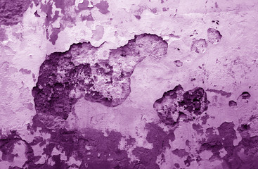 Сraked weathered cement wall texture in purple tone.