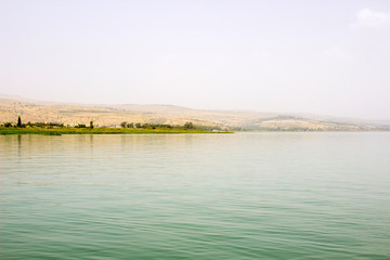 The western shore of the Sea of Galilee taken from a boat.