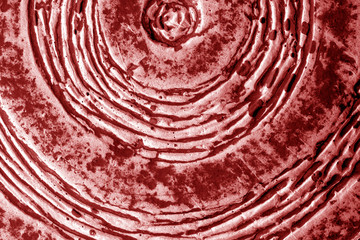 Part of old ceramic plate close-up in red tone.