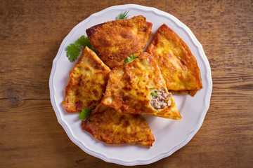 Savor crepes with meat filling. Crepes stuffed with beef sausage. overhead, horizontal