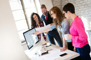 Creative young business people and architects working in office