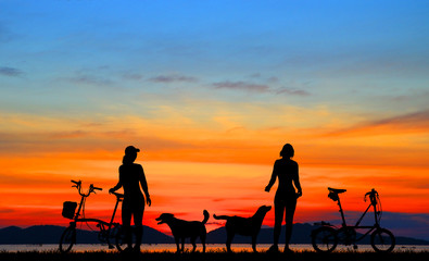 Fototapeta na wymiar Silhouette sport bike and dog relaxing on sunrise