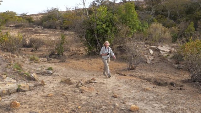 Travel Photographer Hiking In A Beautiful Place Among The Thickets In Dry Season