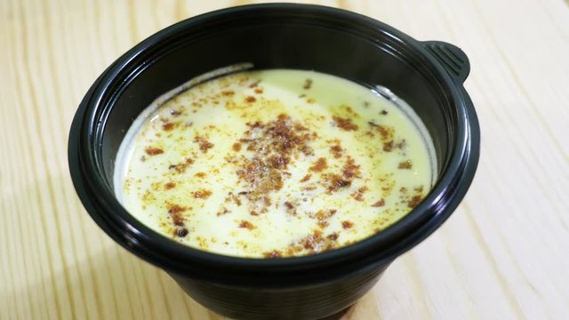 Close-up shot of a cheese cream-soup with croutons in a restaurant. 4K