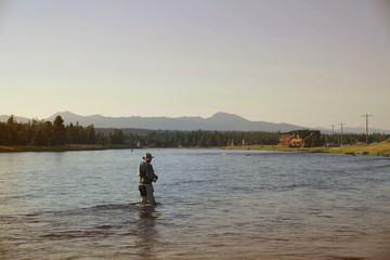 Fototapeta na wymiar Fisherman flyfishing in river of Idaho state