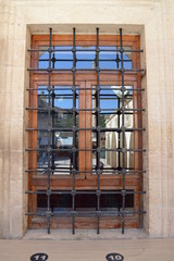 old window behind iron bars
