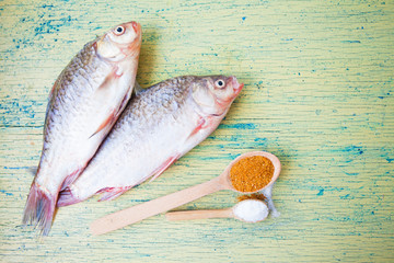 Carp fish over old wooden plank board