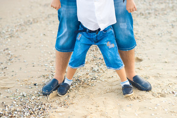 Father and son playing at beach together portrait happy lifestyle