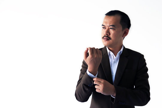 Asian businessman with mustache holding his shirt posting and looking to empty space isolated in white background. Marketing tactics or situation analysis concept.