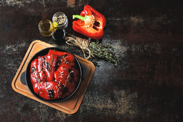 Grilled red paprika with thyme and spices in a cast iron skillet.