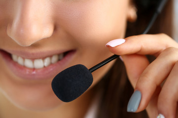 Call centre clerk at work hold in hand mic
