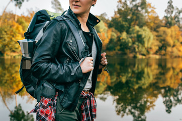 midsection of adult female traveller on autumnal background