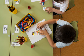 a child making a picture with paintings