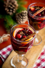 Christmas composition with mulled wine and pine cones on red background