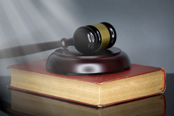 Judge's gavel and book on gray background. Court and the law concept