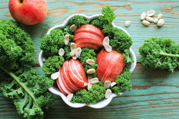 Salad with kale lettuce, apples, peanuts . Top view