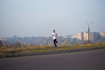 Obraz premium Man run at autumn morning. Healthy lifestyle concept