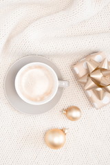 Christmas composition. Xmas decorations, coffee, gift on textile beige background. Christmas, New Year, winter concept. Flat lay, top view, copy space 