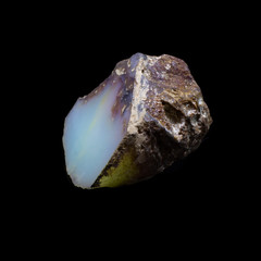 Natural polished opal stone on a black bacrground