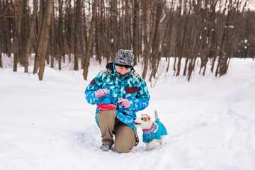 Fototapeta na wymiar Middle aged woman outdoors with cute dog - Jack Russell Terrier in winter season