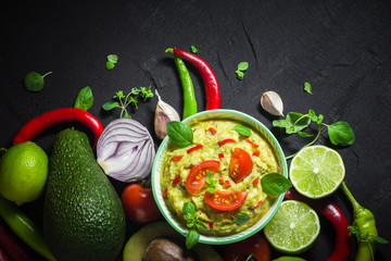 Background bowl guacamole tomato chilli pepper lime onion garlic dill and oregano